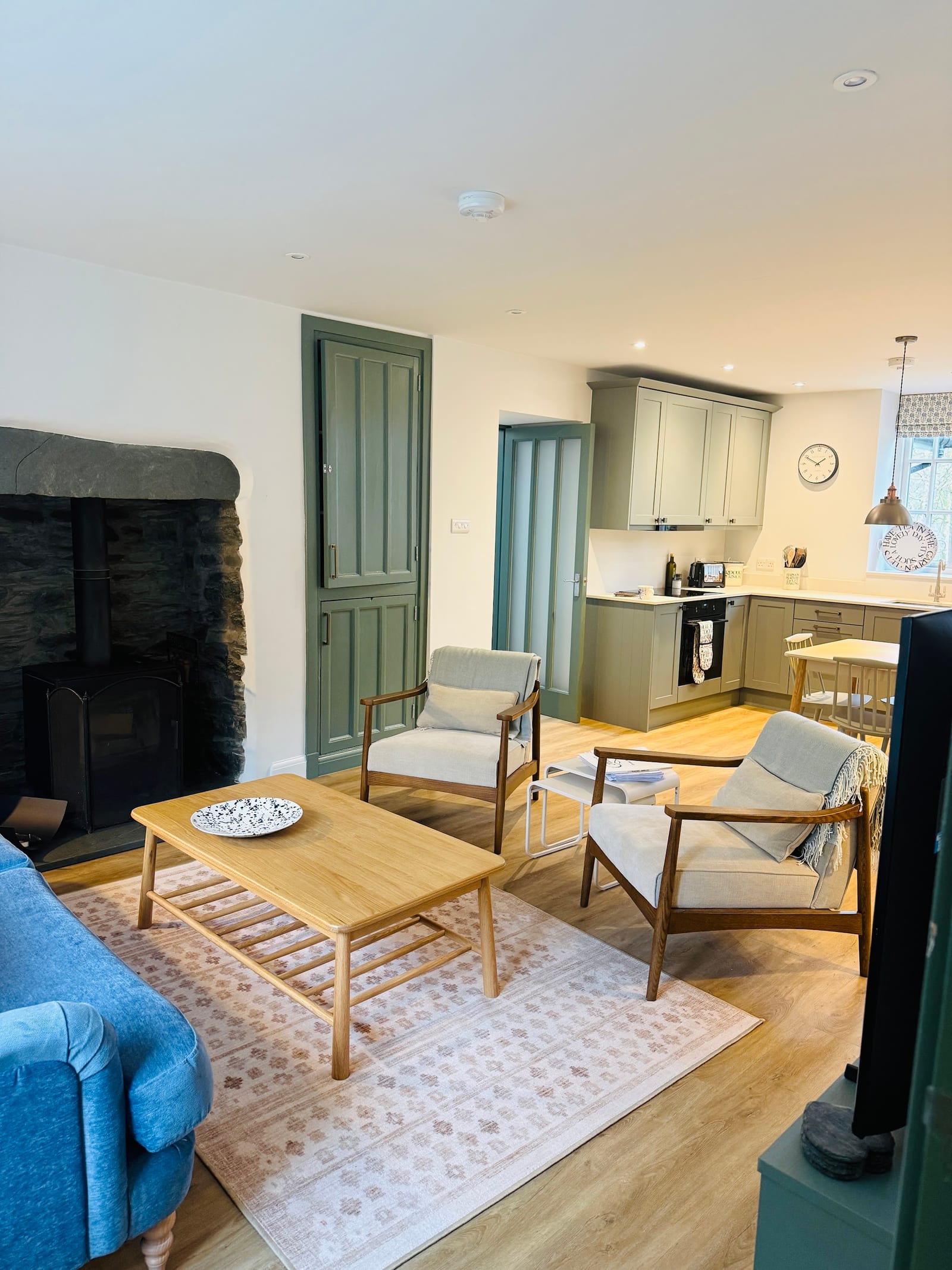 Warm plank flooring connecting an open-plan living room and kitchen